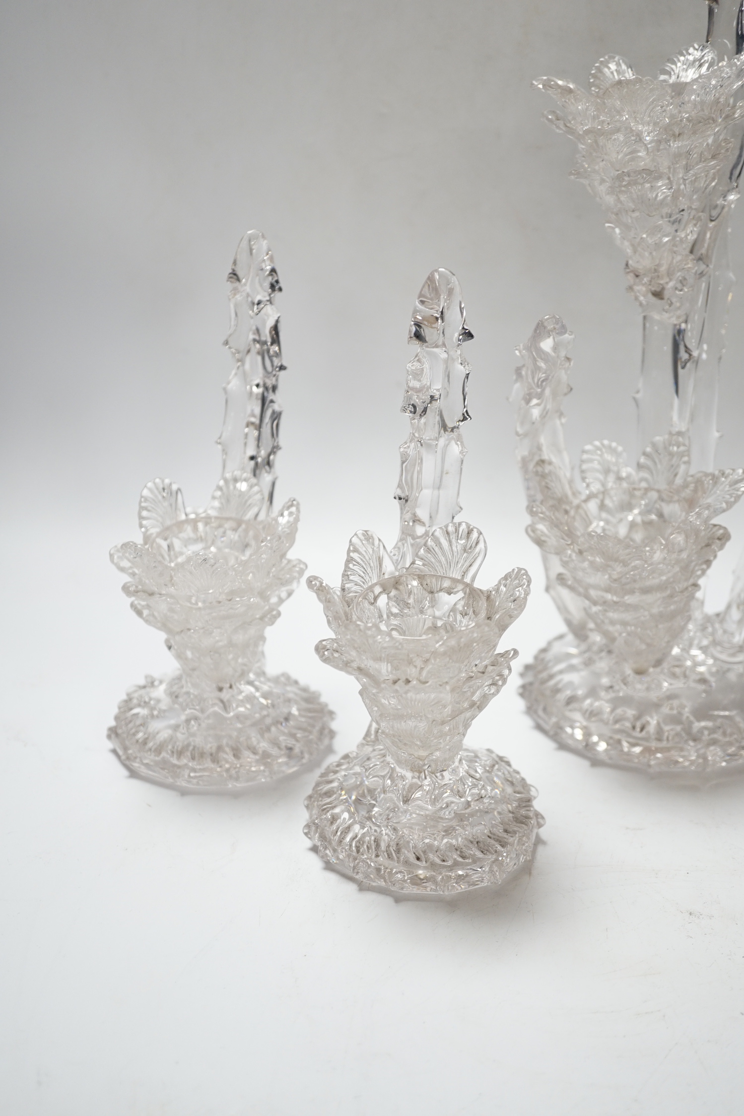 A set of four glass stylistic floral candlesticks, (one double holder the other three single holder), tallest 33cm high